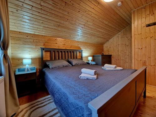 a bedroom with a large bed in a wooden cabin at Casa Emmara Sighisoara in Sighişoara