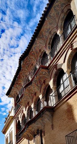 a building with balconies on the side of it at LA CASA MIRADOR DE ÉCIJA in Écija