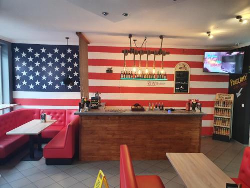 a bar with an american flag painted on the wall at Szymi Pokoje Gościnne in Bytów