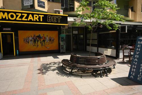 a group of benches in front of a building at Cinema Vardar Apartment in Skopje