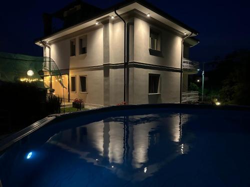 a house at night with a swimming pool in front of it at Villa Sofia in Baveno