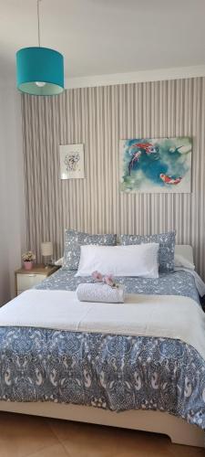 sypialnia z dużym łóżkiem z niebieską lampką w obiekcie Casa nueva en Urbanización la Biznaga w mieście Sierra de Yeguas
