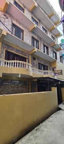 a building with a balcony on the side of it at Hotel August International in Pokhara