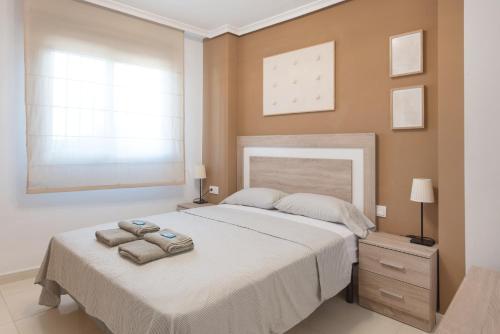 a bedroom with a bed with two towels on it at Blue Marine in Peniscola