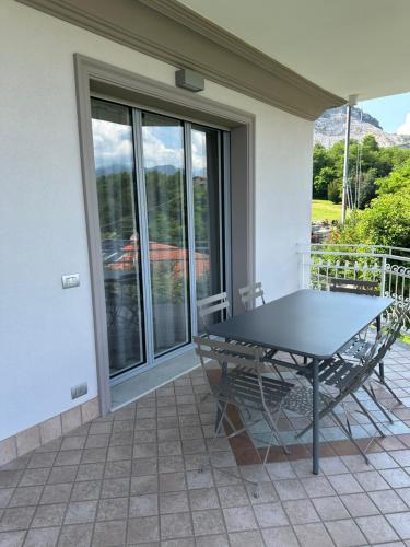 a table and chairs on a patio with a window at Villa Sofia in Baveno