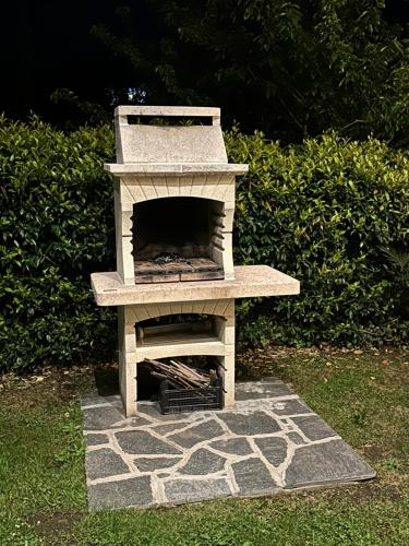 a stone outdoor oven sitting on top of a yard at Villa Sofia in Baveno