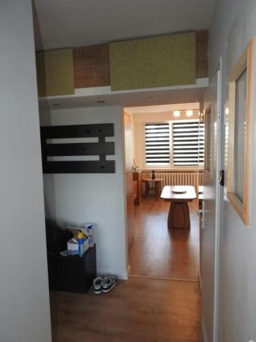 a hallway of a house with a table and a dining room at Apartament Spokojna in Wąbrzeźno
