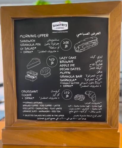 a chalk board with a menu of food on it at Amazing Studio in DAMAC in Amman