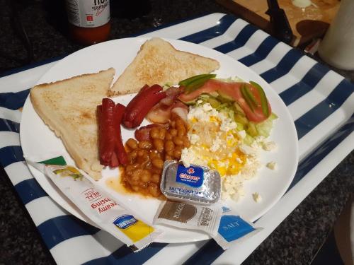a plate of breakfast food with eggs beans and toast at Lerato's in Vanderbijlpark