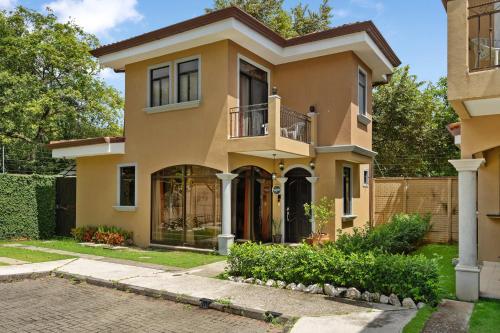 a house in the suburbs with a driveway at Villa with Pool, Gated Playas del Coco Getaway in Coco