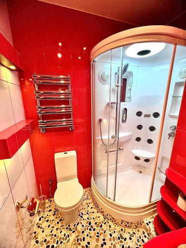a bathroom with a toilet and a shower at Exclusive Golden Sands apartment in Riga