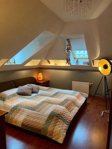 a bedroom with a large bed in a attic at Exclusive Golden Sands apartment in Riga