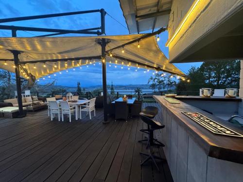 a patio with a bar with lights on a deck at Hotel MACA lago calima in Calima