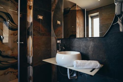 a bathroom with a sink and a mirror at Puteoli Palace Hotel in Pozzuoli