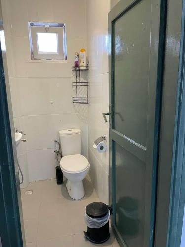a bathroom with a toilet and a glass shower door at Denize 2 km Manzaralı ve Ferah in Gokceada Town