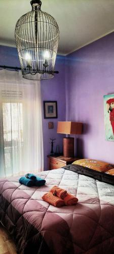 a bedroom with a large bed with purple walls at La Casita b&b in Bagnoregio