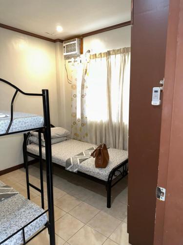 a dorm room with two bunk beds and a purse at Cranberry's Place-near CONVENTION center in Iloilo City