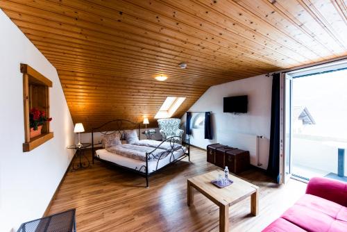 a living room with a couch and a table at Hotel Brienzerburli in Brienz