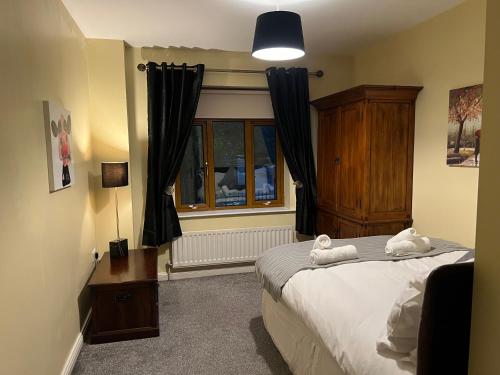 a bedroom with a bed and a window at 2BR Apartment BT9 with balcony in Belfast