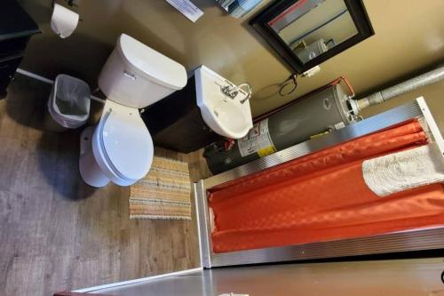 a bathroom with a toilet and a sink and a mirror at Marina View 1 Bedroom Sunset Cabin in Kabetogama