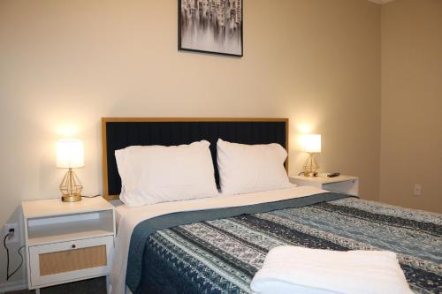 a bedroom with a large bed with two night stands at Lubbock haven Rooms with individual Bathrooms in Lubbock
