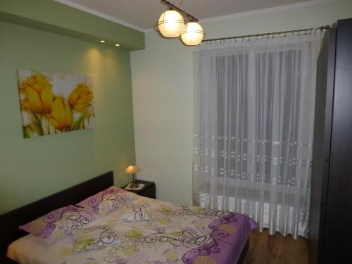 Ένα ή περισσότερα κρεβάτια σε δωμάτιο στο Apartament u Źródła