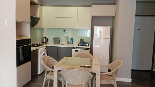 a kitchen with a table and chairs in it at Mali Garden Residence in Side