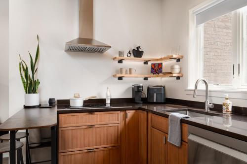 a kitchen with wooden cabinets and a sink at Pulaski Point Properties in Chicago