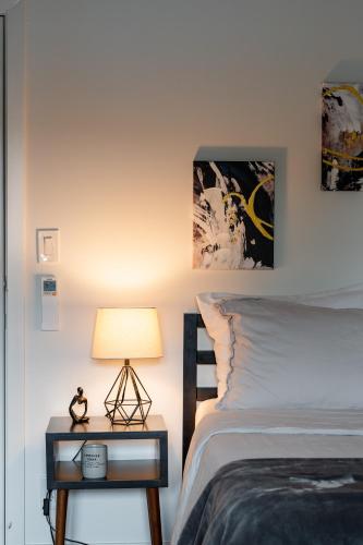 a bedroom with a bed and a table with a lamp at Pulaski Point Properties in Chicago