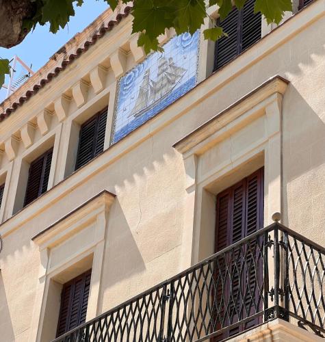a building with a balcony and a sign on it at Vilador Barcelona Beach Hotel in Masnou
