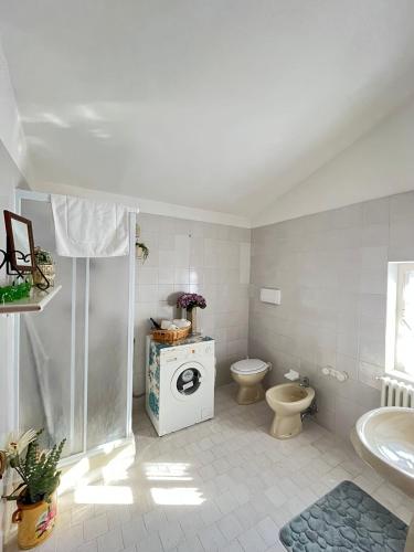 a white bathroom with a toilet and a sink at Chalet del Lago Laceno in Villaggio Laceno