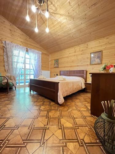 a bedroom with a large bed in a wooden room at Chalet del Lago Laceno in Villaggio Laceno