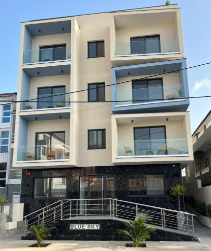 an apartment building with a blue sky in the background at Hôtel Blue Sky in Tarrafal