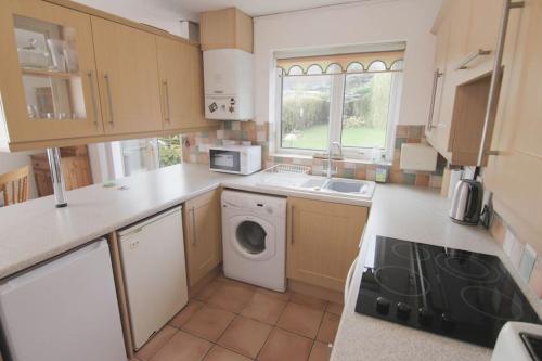 a kitchen with a washer and dryer in it at 2 Bed House - BHX - NEC in Solihull