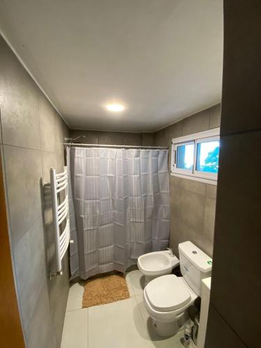 a small bathroom with a toilet and a shower at Departamento 66 - cochera opcional - in La Plata
