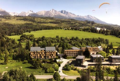an aerial view of a resort with mountains in the background at AR TATRY Hills in Štrbské Pleso