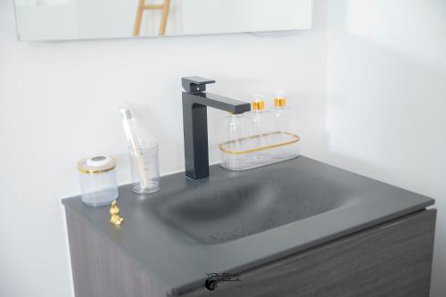 a sink with a faucet on top of a counter at Yolena Villa in Le Gosier