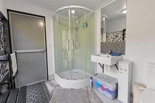 a bathroom with a shower and a sink at Parsons Flat Glamping - Site 2 in Dargo
