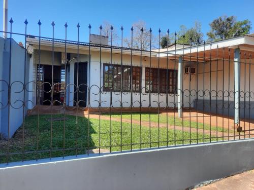 a fence in front of a school building at Maray Loft in Puerto Iguazú