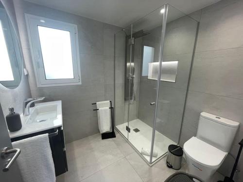 a bathroom with a shower and a toilet and a sink at Luxurious T2 Varandas Apartment XIII in Funchal