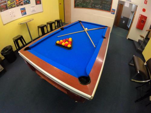a pool table with balls on top of it at Maze Backpackers - Sydney in Sydney