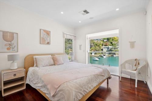 a bedroom with a bed and a large window at The Cove Church Point in Church Point