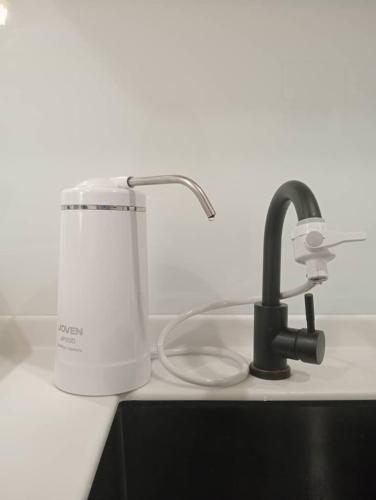 a kitchen sink with a faucet next to a sink at The Shore Seaview A1817 in Kota Kinabalu