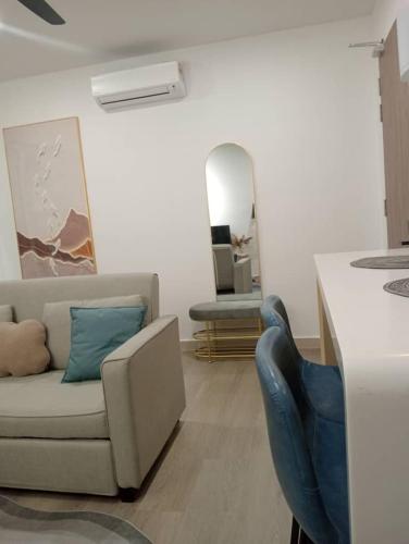 a living room with a couch and a mirror at The Shore Seaview A1817 in Kota Kinabalu