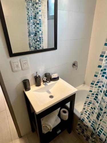 a bathroom with a sink and a mirror and a tub at Arevalito Monoambiente in Buenos Aires