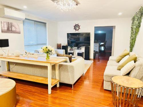 a living room with a couch and a table at D130 The Link Fantasy Place in Keilor