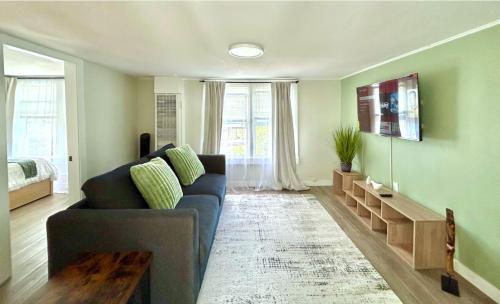 a living room with a blue couch and a table at Charming & Bright Gem Prime Location Street Parking with AC in Renton