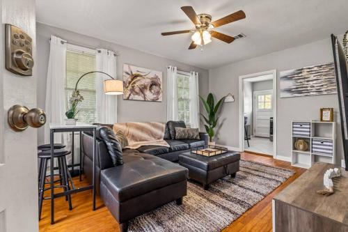 a living room with a couch and a table at East Hill Retreat Near Beaches & Downtown in Pensacola