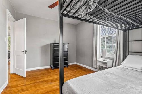 a bedroom with a loft bed and a window at East Hill Retreat Near Beaches & Downtown in Pensacola