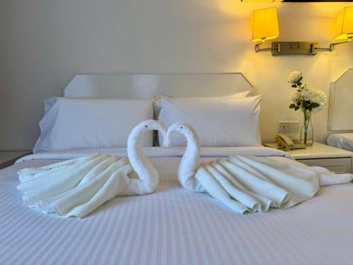 two swans towels are made to look like they are on a bed at ROYAL PARK HOTEL @ UNITEN in Kajang